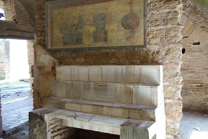 Ancient Ostia Antica Semi-Private Day Trip from Rome by Train with Guide - Amphitheater views and the Forum of the Corporations