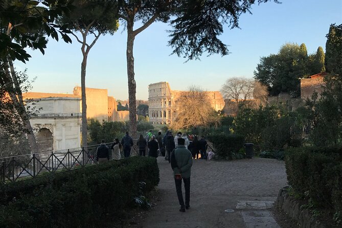 Colosseum, Forum, Palatine Hill with audio guide and Arena or Bus option - Walking through the Roman Forum