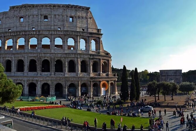 Rome: Colosseum, Forum, & Palatine Hill with Audio Guide - Entering the Colosseum with a phone in hand
