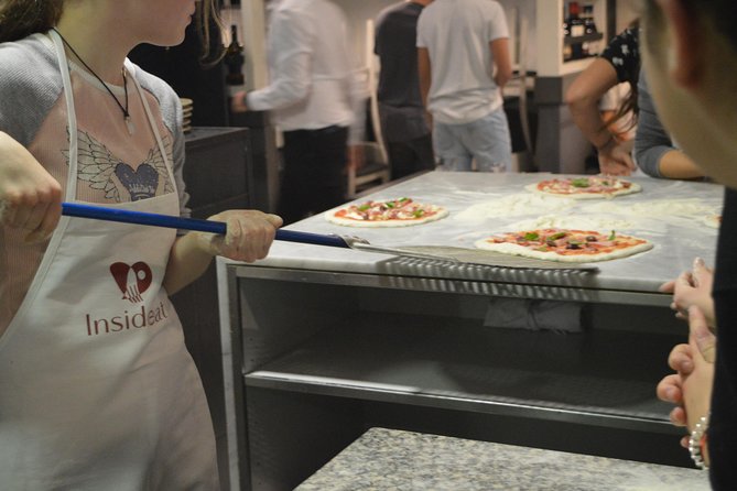 Rome: Pizza Making Class Small Group Experience - Sliding your pizza into the oven