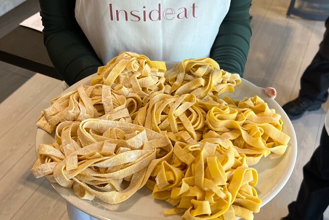 Rome Small Group Pasta Making Class with Wine and Italian Chef - Cutting fettuccine and preparing the meal